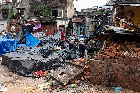 Shopkeepers try to salvage their belongings and inspect damaged structures after the Jammu Municipal Corporation (JMC) carried out a demolition drive at Parade Sabzi Mandi in the Old City area of Jammu. Over a dozen makeshift and concrete shops were dismantled under heavy security as part of a Smart City redevelopment project aimed at modernizing the market and addressing monsoon safety hazards posed by dilapidated structures.