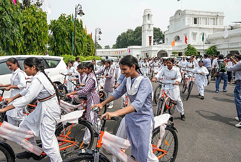 Students ride bicycles distributed by Delhi Chief Minister Rekha Gupta during the Delhi Assembly Monsoon Session, at Vidhan Sabha, in New Delhi.