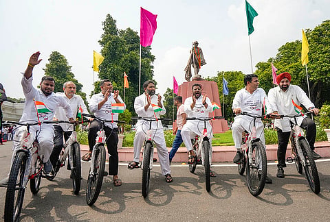 AAP and opposition leaders ride bicycles as they stage a protest against an alleged bicycle scam by Delhi Government during the Delhi Assembly Monsoon Session, at Vidhan Sabha, in New Delhi.