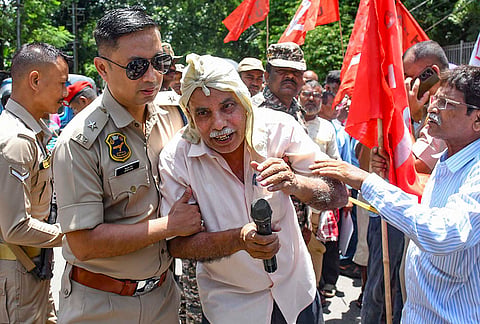 Security personnel detain an activist from left-wing mass organisations, including the Centre of Indian Trade Unions (CITU), All India Kisan Sabha (AIKS), and All Assam Krishak Sabha, during a joint nationwide 'Jail Bharo' protest march held to press for various worker and farmer demands, in Guwahati, Assam.