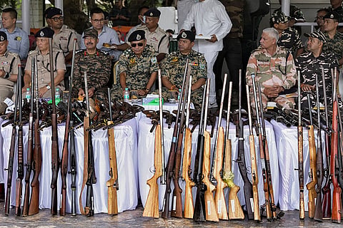 Arms, ammunition and explosives recovered by the security forces and law-enforcement agencies in Manipur between February 5 and August 11 are displayed during an event at the 1st Manipur Rifles Parade Ground, in Imphal.