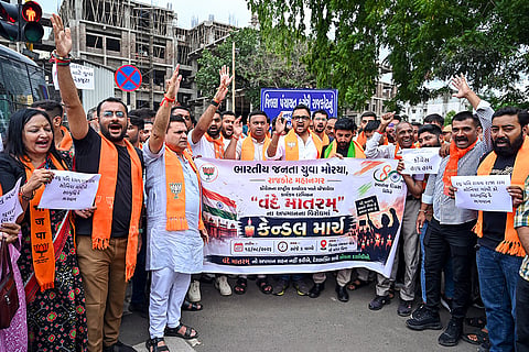 Bharatiya Janata Yuva Morcha (BJYM) activists hold a banner and shout slogans during a candle march protest outside the Congress office, in Rajkot, Gujarat. The youth wing of the BJP staged a protest and a candle march against the Congress leadership over the alleged disrespect shown to the national song, 'Vande Mataram', during an Independence Day event.