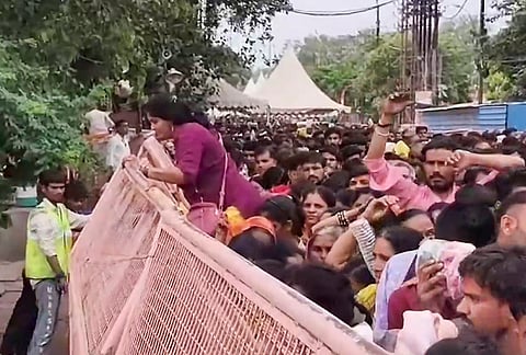 A massive crowd of devotees queue up and navigate barricades to offer prayers at the Mahakaleshwar Temple on the auspicious occasion of 'Shravan Somvar' coinciding with the 'Nag Panchami' festival, in Ujjain, Madhya Pradesh.