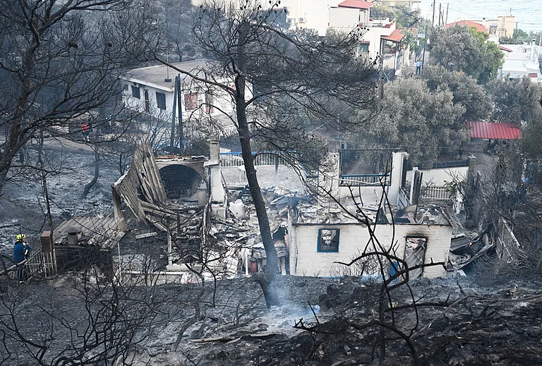 A home is in ruins after it was burned by a wildfire on the island of Salamina, west of Athens, Greece, Sunday, Aug. 16, 2026. - | Photo: AP/Michael Varaklas