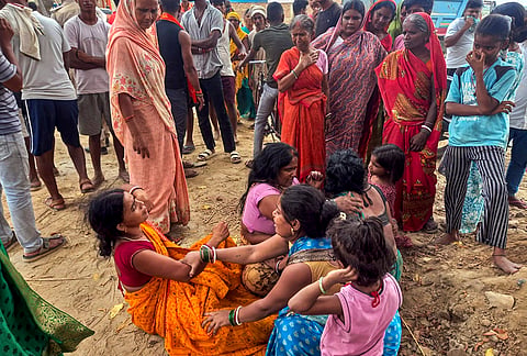 Grieving family members mourn the loss of four children from the same family who tragically drowned while bathing at the Ranisarai Ganga Ghat in the Bakhtiyarpur area, on the banks of the Ganga river, in Patna district, Bihar.