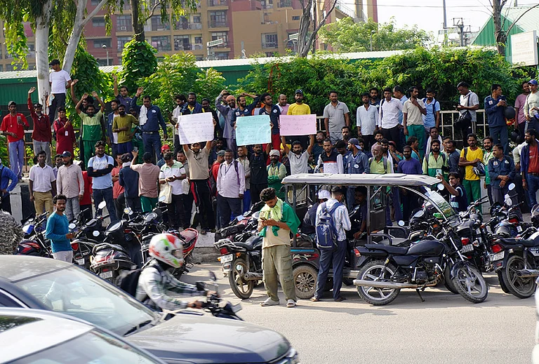 Sanitation workers and auto-tipper drivers from across Delhi stage a protest following the death of a 27-year-old sanitation worker who was stabbed to death in Kalyanpuri, demanding compensation and a permanent government job for a member of the family of the deceased, in New Delhi, Tuesday, Aug. 18, 2026. - | Photo: PTI