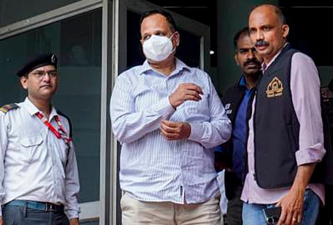 AAP leader Satyendar Jain, centre, leaves for court after an arrest by the Anti-Corruption Branch in connection with an alleged corruption case involving the tendering process for sewage treatment plant projects of the Delhi Jal Board, in New Delhi.