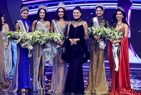 Miss Universe India 2026 winner Kaziah Liz Mejo from Keralam, third left, first runner-up Vaishnavi Ganesh of Tamil Nadu, second right, second runner-up Anushri Satavlekar of Gujarat, second left, and others pose for photographers with Bollywood actor Sushmita Sen during the event, in Jaipur, Rajasthan.
