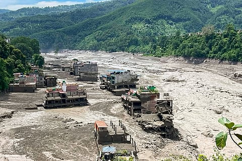 In this image received on Aug. 26, 2026, A torrent of muddy water flows through the Trishuli River following a flash flood triggered by the Lende river, and merges into the Bhote Koshi river, in Trishuli, Nepal.