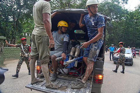 Rescuers transport the body of a flash flood victim in a truck to a hospital in Nepal's Nuwakot district.