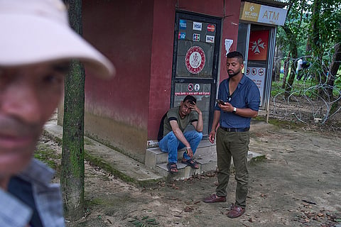 People wait for news of their relatives who are missing after flash flooding along the Trishuli River in Nepal's Nuwakot district.