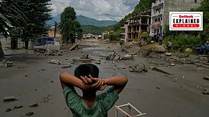 AP Photo/Niranjan Shrestha : A boy looks at the devastation caused by flash flooding along the Trishuli River in Nepal's Nuwakot district