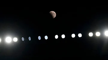 | Photo: AP/Carolyn Kaster : A partial lunar eclipse is seen above the stadium light during a pre-season NFL football game between the Cleveland Browns and the New England Patriots, Thursday, Aug. 27, 2026, in Cleveland.