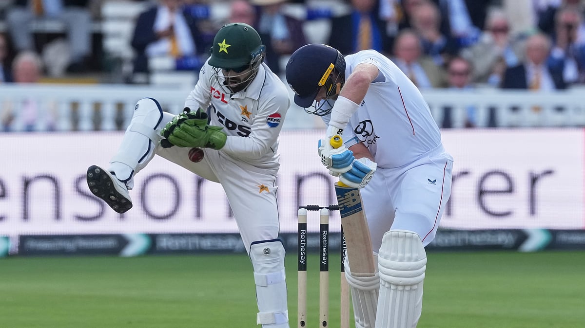 Pakistan's Mohammad Rizwan, left, attempts to collect the ball as England's captain Joe Root bats on day two of the second cricket test match between England and Pakistan in London, Friday, Aug. 28, 2026. - (AP Photo/Dave Shopland)