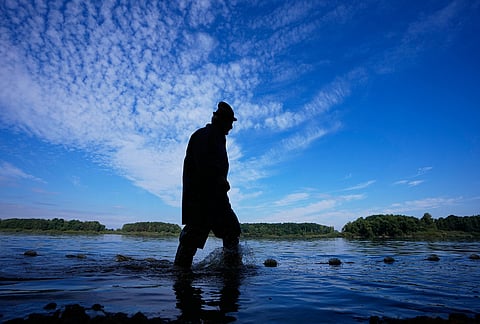 A fisherman takes part in a fish haul of the Kanov pond near the town of Trebon, Czech Republic, Wednesday, Aug. 26, 2026. 