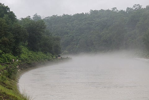 A view of the mist rising from the Chilla power channel canal with dense monsoon greenery covering the surrounding banks after rainfall, in Rishikesh, Uttarakhand.