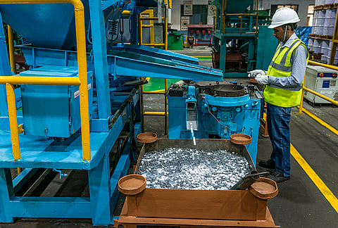 A worker monitors the production of coin blanks at the Special Products Division of Jindal Stainless, in Hisar, Haryana. 
