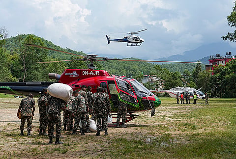 Army personnel load packages of relief material onto a rescue helicopter at an army camp, in Trishuli, Nuwakot district, Nepal. The operation is part of the ongoing emergency search and rescue efforts following the catastrophic flash floods and mudslides triggered by a Himalayan glacier collapse. 
