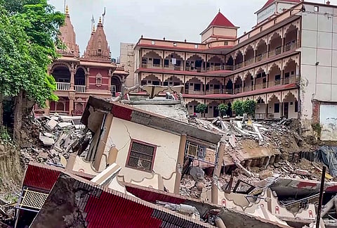 A view of the debris after a portion of the Swaminarayan temple premises collapsed into a deep crater caused by heavy rainfall, in Prayagraj, Uttar Pradesh