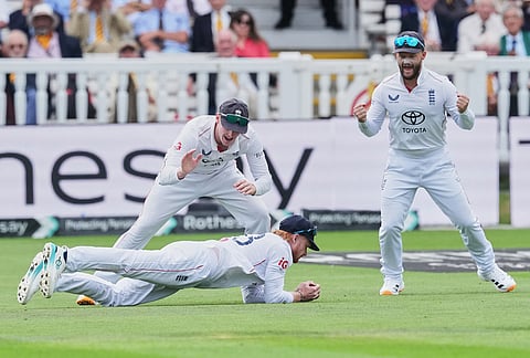 England's Jordan Cox dives to complete the catch to dismiss Pakistan's captain Babar Azam as teammates Harry Brook and Ben Duckett, right, applaud on day two of the second cricket test match between England and Pakistan in London, Friday, Aug. 28, 2026. 