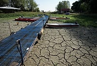 | Photo: AP/Darko Vojinovic : Boats sit on dry ground as water levels have dropped on the Danube River in Petrovaradin, Serbia, Tuesday, Aug. 25, 2026. 