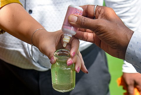 Officials from the Fishery Department test a water sample collected from the Jor Pukhuri pond following reports of fish deaths, in Guwahati, Assam. Preliminary tests indicated that the pond water is polluted, posing a significant threat to aquatic life including fishes and tortoises. 