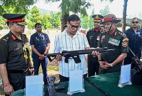 Assam Chief Minister Himanta Biswa Sarma inspects a firearm during his visit to Assam Regimental Centre, in Shillong. 