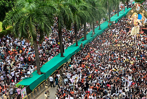 People carry an idol of Lord Ganesh to a 'Pandal' ahead of the 'Ganesh Chaturthi' festival in Mumbai.
