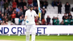 Joe Root celebrates hitting a half century on day two of the first Test against Pakistan in Leeds - Photo: Associated Press