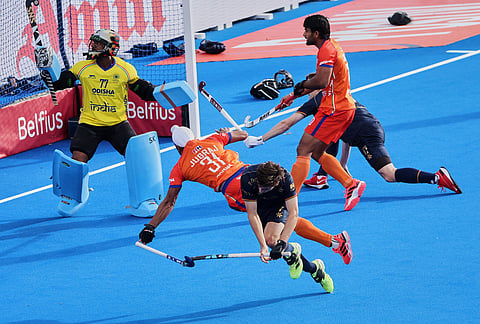 Belgium's Thibeau Stockbroekx, center, takes a shot on goal as India's Jugraj Singh, second left, defends during the World Cup Field Hockey, 7th and 8th place playoff match, between Belgium and India in Wavre, Belgium, Friday, Aug. 28, 2026. 
