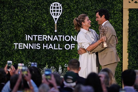 Roger Federer is embraced by his wife Mirka during his induction ceremony at the International Tennis Hall of Fame in Newport, R.I.
