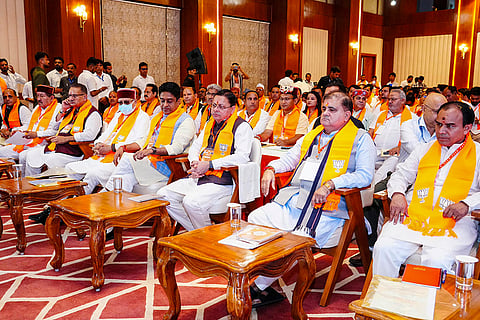 In this image posted on Aug. 30, 2026, Uttarakhand CM Pushkar Singh Dhami and others listen to Prime Minister Narendra Modi's 'Mann Ki Baat' radio programme.