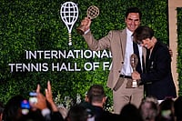| Photo: AP/Charles Krupa : Roger Federer embraces Mary Carillo, who was honored as a broadcast contributor, during the induction ceremony at the International Tennis Hall of Fame in Newport, R.I.