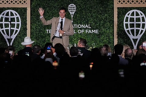 Roger Federer acknowledges fans during his induction ceremony at the International Tennis Hall of Fame in Newport, R.I.