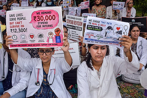 MBBS and BDS interns hold placards and stage a protest outside Government Medical College hospital (GMCH) to increase their monthly stipends, in Jammu.