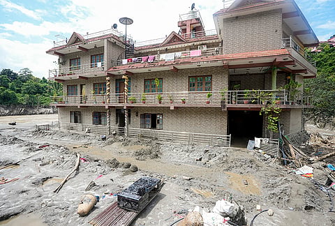 Damaged houses remain covered in mud and silt in the aftermath of the recent flash floods, in Galchhi, Dhading district, Nepal, Sunday, Aug. 30, 2026. 