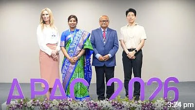 Dr. Shree Rao standing alongside international delegates on stage at APAC 2026
