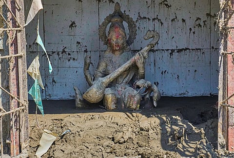 Mud brought in by the recent flash floods surrounds a statue of the Hindu Goddess of learning Saraswati, placed at the entrance of the Shree Bagheswori Madhyamik School in Galchhi, Dhading district of Nepal Sunday, Aug. 30, 2026. 