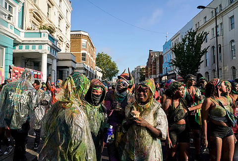 Revellers attend the J'Ouvert, the opening event of the Notting Hill Carnival, in London, Sunday, Aug. 30, 2026. 
