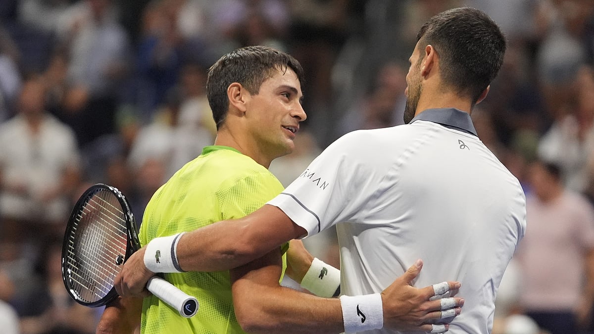 Novak Djokovic, of Serbia, right, embraces Mariano Navone, of Argentina, after Navone won their match during the first round of the U.S. Open tennis championships Sunday, Aug. 30, 2026, in New York - (AP Photo/Frank Franklin II)