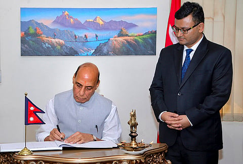 Defence Minister Rajnath Singh signs a condolence book at the Embassy of Nepal following the loss of lives in Nepal, in New Delhi.