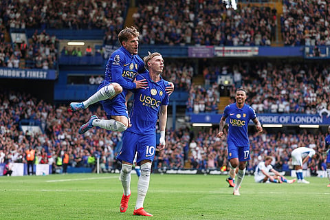 Chelsea's Cole Palmer, centre, celebrates with teammates after scoring his side's fourth goal during the English Premier League soccer match between Chelsea and Brighton and Hove Albion in London.