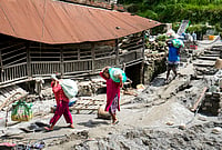 | Photo: PTI/Nand Kumar : People carrying relief material move to a safer place in the aftermath of the recent flash floods, in Galchhi, Dhading district, Nepal, Sunday, Aug. 30, 2026. 