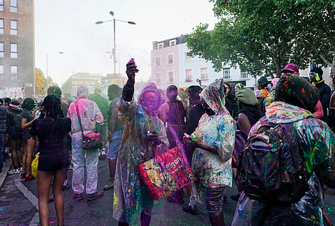 Revellers attend the J'Ouvert, the opening event of the Notting Hill Carnival, in London, Sunday, Aug. 30, 2026. 