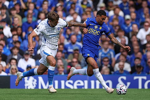 Brighton's Luka Vuskovic, left, challenges for the ball with Chelsea's Morgan Rogers during the English Premier League soccer match between Chelsea and Brighton and Hove Albion in London.