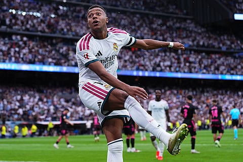 Real Madrid's Kylian Mbappe celebrates after scoring his sides third goal during the La Liga soccer match between Real Madrid and Malaga in Madrid, Spain.