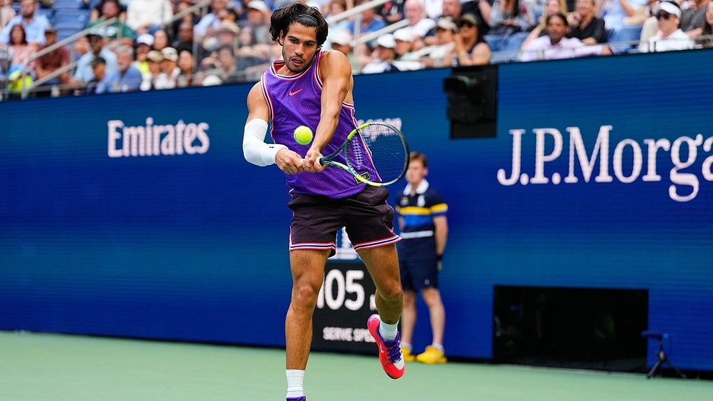 Carlos Alcaraz, of Spain, returns the ball during a mixed doubles match at the U.S. Open tennis championships, Tuesday. - Yuki Iwamura/AP Photo