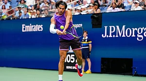Yuki Iwamura/AP Photo : Carlos Alcaraz, of Spain, returns the ball during a mixed doubles match at the U.S. Open tennis championships, Tuesday.