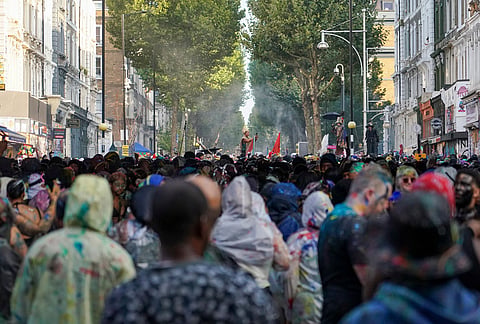 Revellers attend the J'Ouvert, the opening event of the Notting Hill Carnival, in London, Sunday, Aug. 30, 2026. 