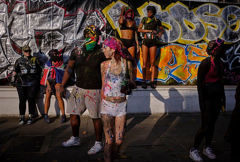 Revellers attend the J'Ouvert, the opening event of the Notting Hill Carnival, in London, Sunday, Aug. 30, 2026. 